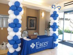 a blue and white table with balloons on it