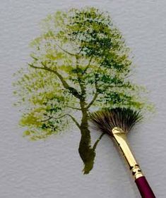 a paintbrush with a tree painted on it