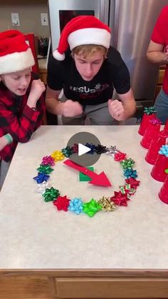 two boys are making christmas wreaths on the kitchen counter while another boy is looking at them