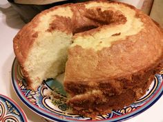 a bundt cake on a plate with one slice cut out and ready to be eaten