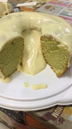 a green cake with white icing on a plate