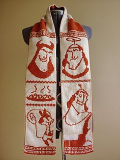 a white scarf with red designs on it