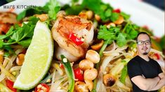 a man standing in front of a plate of food with shrimp and veggies