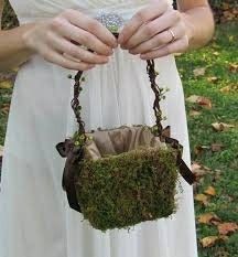 a woman in white dress holding a purse with moss on it