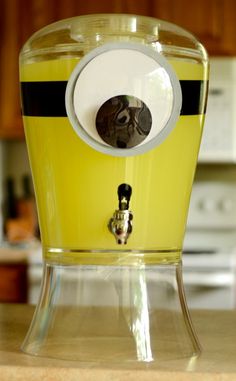 a yellow juicer sitting on top of a wooden counter