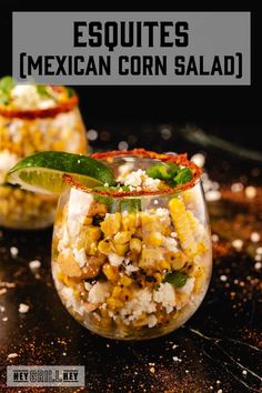 two glasses filled with mexican corn salad on top of a table