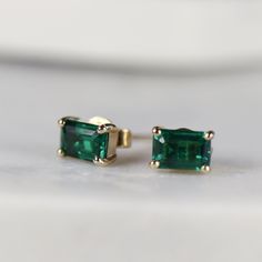 14k gold emerald cut emerald stud earrings. Sophisticated and elegant studs. DETAILS ABOUT THE EARRINGS, MATERIAL AND STONES Settings, posts and backings : 14K solid gold Gemstone: Lab grown Emerald Emerald size: 6mm x 4mm emerald cut Yellow gold or white gold options available from drop down menu. It is a great birthday gift for your special ones whose birthday are in May, since Emerald is May birthstone. This solid gold earrings make a perfect present for your anniversaries. Emerald is especia Classic Emerald Cut Emerald Earrings, Gold Emerald Earrings, 20th Anniversary Gifts, Emerald Stud Earrings, Earrings Emerald, Emerald Earrings Studs, Solid Gold Earrings, Emerald Earrings, Anniversary Gift For Her