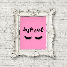 a pink poster with eyelashes and the words lashes out on it in front of a white frame