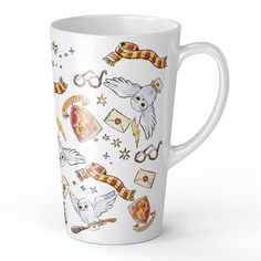 a harry potter themed coffee mug with hogwart symbols