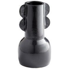 a black vase sitting on top of a white table