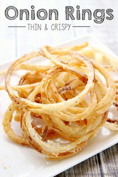 onion rings on a white plate with the words onion rings thin and crispy above it