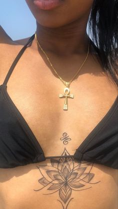 a woman with a cross tattoo on her chest