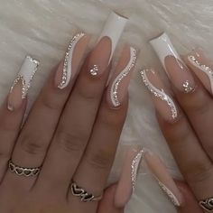 two hands with white and silver nail designs on them