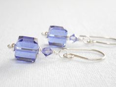 These lavender cube earrings feature Swarovski Crystals in Tanzanite.  Each Swarovski crystal cube is topped with a silver spacer bead and another small crystal.  The tanzanite purple beaded drop earrings dangle from sterling silver earring wires.  The last photo shows the earrings in Fuchsia (sold separately).  Other colors are available in my shop. Swarovski cube crystals measure 8mm.  Small crystals are 4mm.  Silver plated beads.  Sterling silver ball headpins and earring wires. Total length: Cube Earrings, Purple Beaded, Swarovski Crystal Jewelry, Earrings Purple, Beaded Drop Earrings, Silver Dangle Earrings, Swarovski Crystal Earrings, Silver Plated Jewelry, Swarovski Earrings