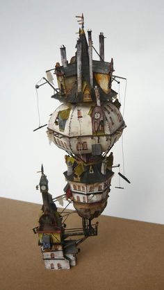 a tall tower with lots of different types of buildings on it's sides and towers