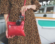 This small red crossbody bag is small enough to wear out for a quick trip to the corner store, but large enough to fit your phone, keys, wallet and sunglasses. Lined with a limited-edition printed fabric.6.5" wide x 7.5" h54" long adjustable strapbig enough to fit iPhone xoutside zipper pocketZero waste bag - upcycled glazed fabric and vintage fabric100% cruelty-free vegan handbag Made in USA Versatile Red Phone Bag For Everyday Use, Red Versatile Phone Bag For Everyday Use, Red Shoulder Bag For Travel With Cell Phone Pocket, Red Travel Shoulder Bag With Cell Phone Pocket, Red Leather Phone Bag For Travel, Red Leather Travel Phone Bag, Red Phone Bag With Cell Phone Pocket For Travel, Red Shoulder Bag With Cell Phone Pocket For Travel, Red Crossbody Phone Bag