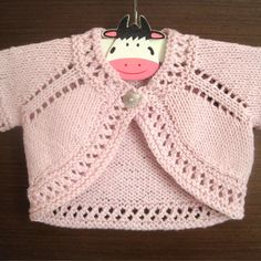 a knitted sweater with a cow head hanging from it's front and back