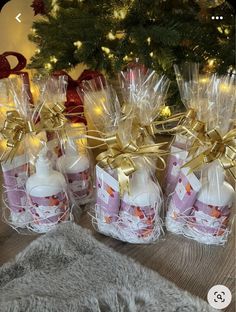 small bottles filled with baby's hand sanitizers in front of a christmas tree