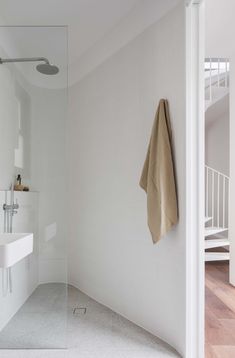 a bathroom with a sink, mirror and towel on the wall