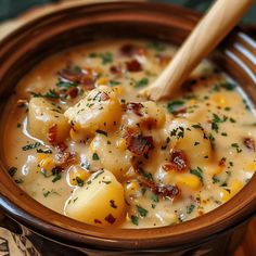 a close up of a bowl of food with a wooden spoon in it on a table