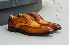 Style: 509-43T-Tan/Cognac Extremely comfortable, this Exquisite new lace-up Wingtip Blucher Oxford from our Maurice collection in Hand Burnished Two-Tone Leather features a Wingtip Design, Decorative Perforations and Pinking Detail, and a clean, stitched welt! Cordovan Shoes, Shoe Horn, Shoe Tree, Mens Casual Outfits, Suede Shoes, Lace Up Shoes, Shoe Box, Leather And Lace, New Shoes