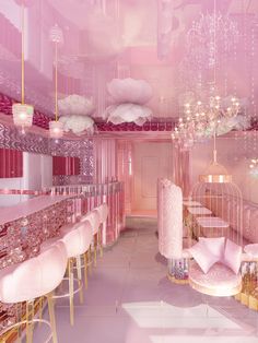 a room with pink walls and chandeliers hanging from the ceiling