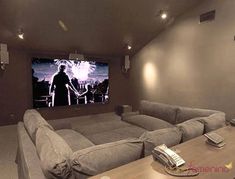 a large gray couch sitting in front of a flat screen tv