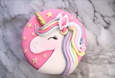 a close up of a cake shaped like a unicorn