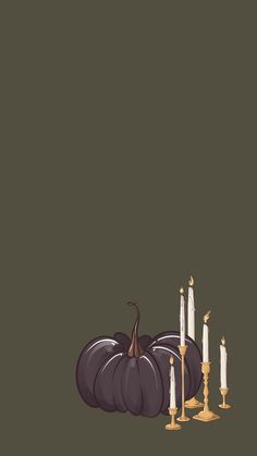 a group of white candles sitting next to a black pumpkin