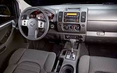 the interior of a car with grey leather seats and dash board, steering wheel and dashboard