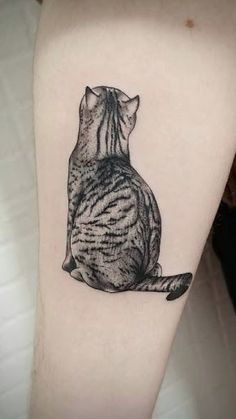 a black and white cat tattoo on the right arm, it looks like he is sitting down