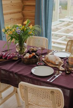 the table is set with food and flowers