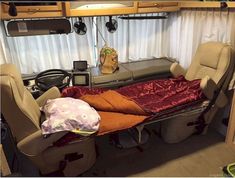 an rv bed is in the middle of a room with cabinets on either side of it