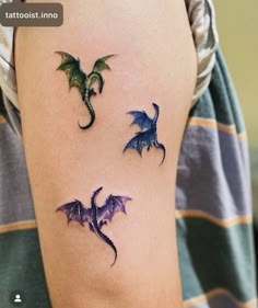 two small dragon tattoos on the arm