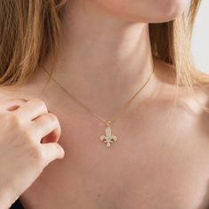 This Solid Gold Fleur de Lis Necklace is an excellent choice for a fine jewelry gift or something special for yourself! It will make an ideal Christmas, anniversary, or Valentine's Day present for her. This delicate gold necklace with a distinctive design looks excellent on its own or with other basic pieces of jewelry. Made of 10K and 14K solid gold. Details of the product Material: 10K and 14K Solid Gold Elegant Gift For people whom you love; Mom, Girlfriend, Wife, Fiance, Best Friend; Dainty Exquisite 14k Stamped White Gold Jewelry, Engraved Yellow Gold Cubic Zirconia Necklace, Fine Jewelry Flower Pendant Tarnish Resistant, Elegant 14k Stamped Flower Pendant Jewelry, Fine Jewelry With Tarnish Resistant Flower Pendant, Elegant 14k Gold Hallmarked Charm Necklace, Elegant 14k Stamped Flower Pendant Necklace, Elegant 14k Gold Flower Pendant Necklace, Gold Flower Pendant Jewelry With Diamond Cut