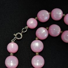 "This vintage necklace is lovely! Single stranded, it features pink moonglow plastic beads (possibly lucite), small metal bead spacers, and has a spring ring clasp. Beautiful! Measures 24.25\" from end to end. Condition : Good.. There's light wear on the beads." Pink Polished Round Bead Necklaces, Pink Round Polished Bead Necklaces, Pink Beads For Jewelry Making, Pink Round Beaded Necklaces With Spacer Beads, Vintage Pink Single Strand Jewelry, Pink Spacer Beads, Vintage Pink Beaded Necklaces, Vintage Pink Beaded Jewelry, Vintage Pink Beaded Necklace