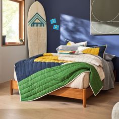 a bedroom with a surfboard on the wall and a bed in front of it