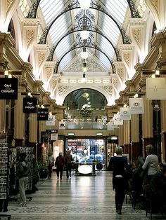 people are walking through an indoor shopping mall