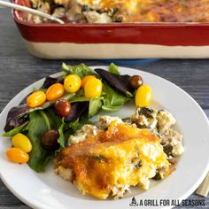 a white plate topped with food next to a casserole dish