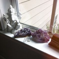 three different types of crystals sitting on a window sill