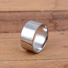 a silver ring sitting on top of a wooden table