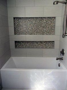 a white bath tub sitting inside of a bathroom next to a shower faucet