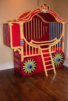 a child's bed made to look like a horse drawn carriage with wheels on it