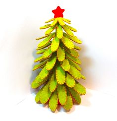 a pine cone shaped christmas tree with a red star on it's top, against a white background