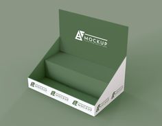 an open cardboard box mockup with the logo on top and bottom, sitting on a green surface