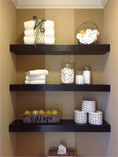 bathroom shelves with towels and baskets on them