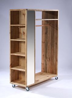 a wooden cabinet with mirrored doors and wheels on the bottom shelf is shown against a white background