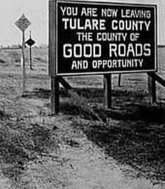 there is a sign that says you are now leaving tulare county the country of good roads and opportunity