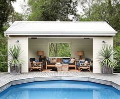 an outdoor living area with a pool and patio furniture