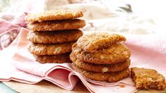 a stack of cookies sitting on top of a pink napkin